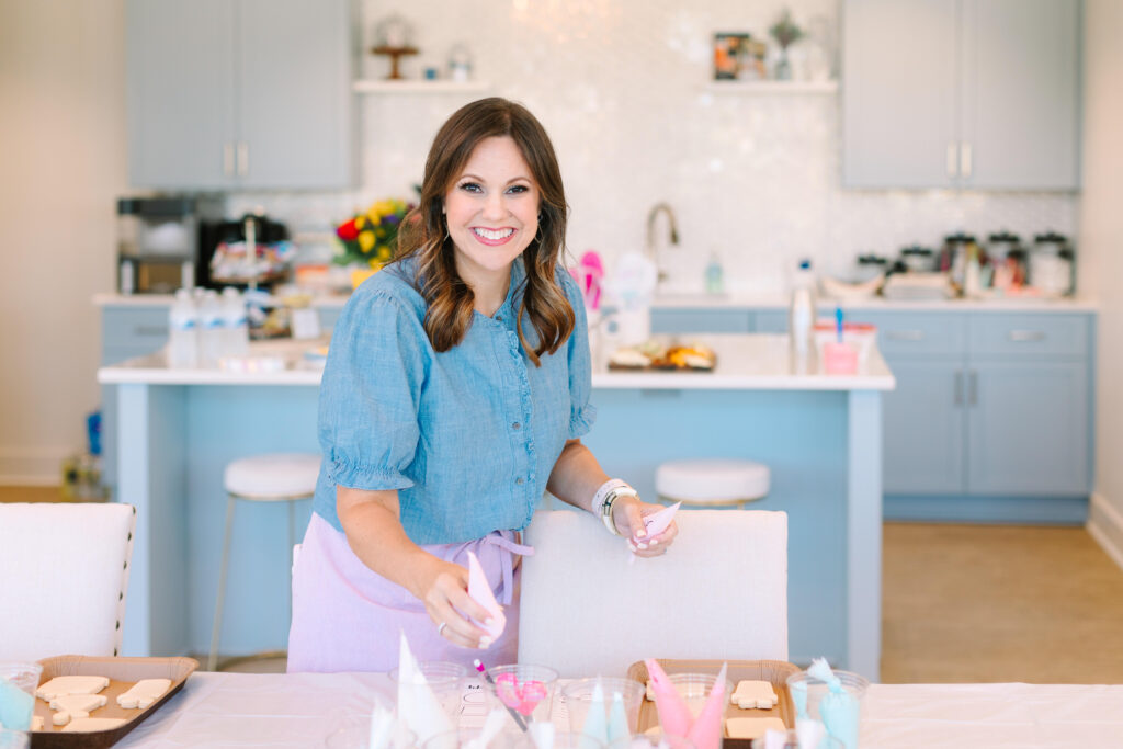 A woman holding a piping bag full of icing